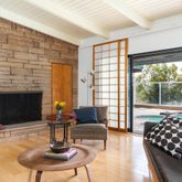 a living room with fireplace furniture and a large window