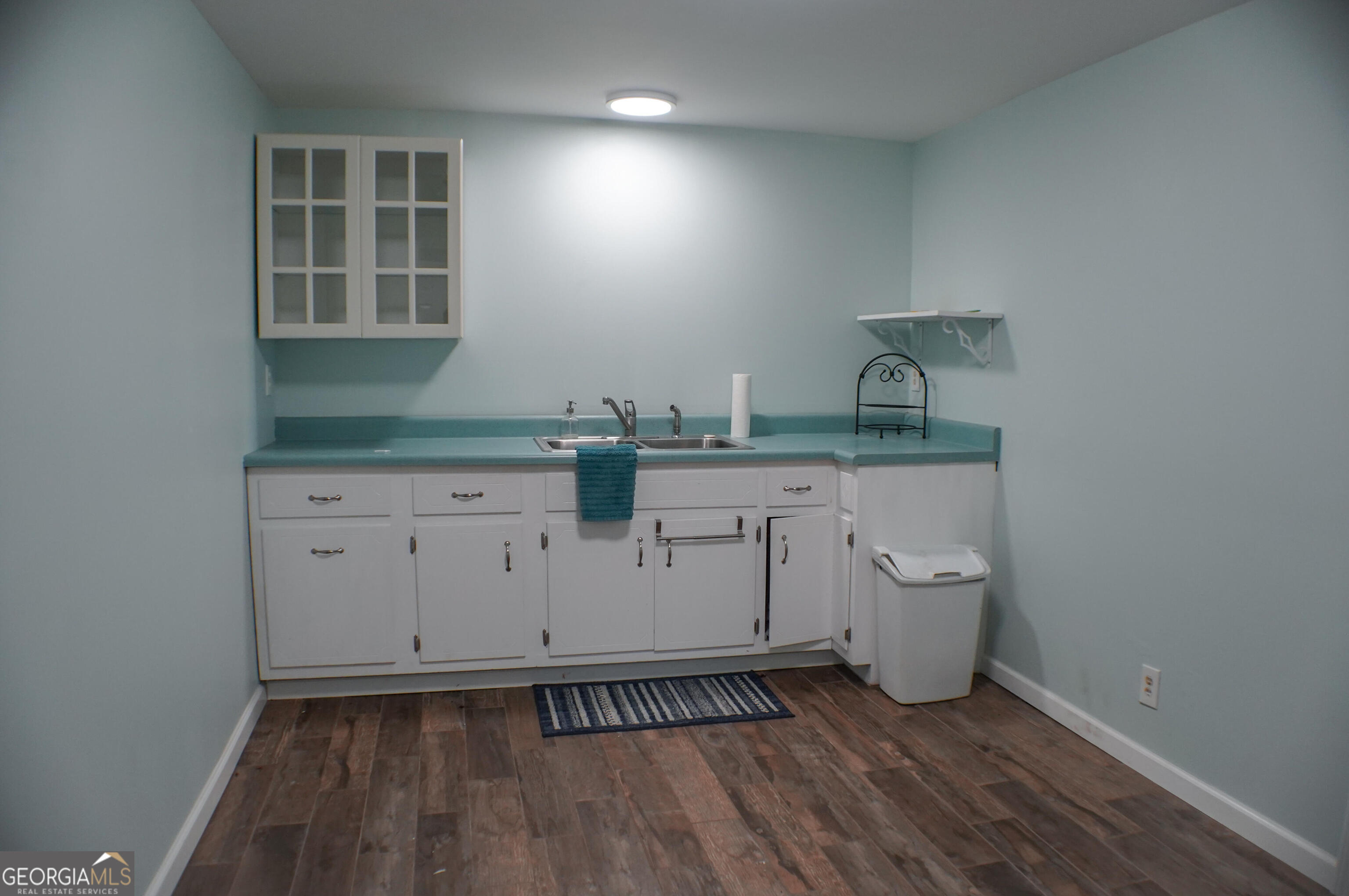 335 Winding Stream Trail Hampton, GA 30228 - Photo 29 of 35 a view of cabinets and wooden floor