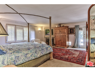 1467 Roscomare Road Los Angeles, CA 90077 - Photo 5 of 19 a bedroom with a bed closet and a large window
