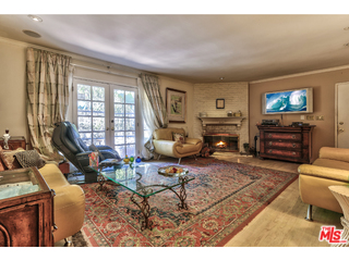 1467 Roscomare Road Los Angeles, CA 90077 - Photo 8 of 19 a living room with furniture a flat screen tv and a fireplace
