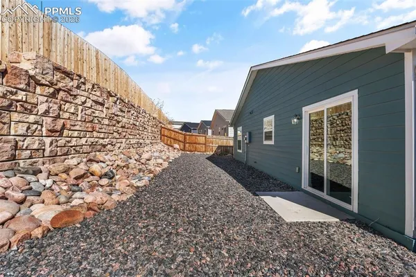 a view of a pathway along a house with wooden floor