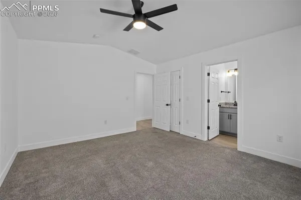 a view of a room with a ceiling fan