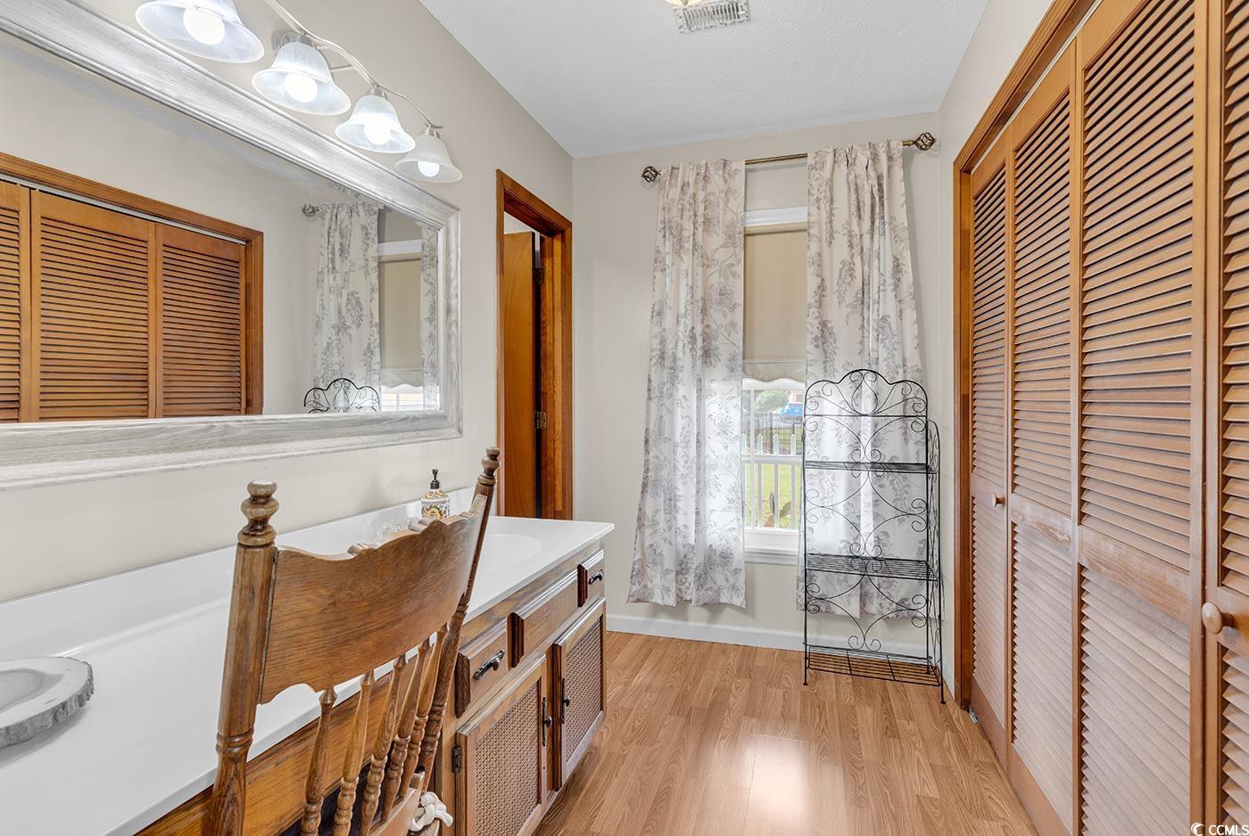 4 Plantation Road Myrtle Beach, SC 29588 - Photo 18 of 40 Full bath featuring a closet, light wood finished floors, and vanity