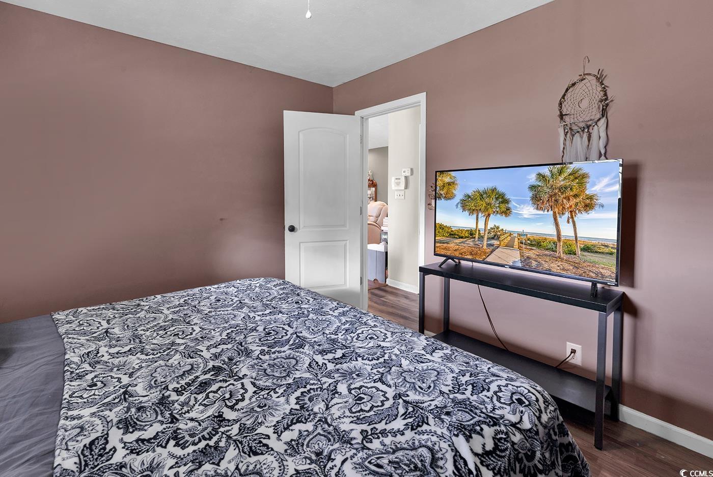 4 Plantation Road Myrtle Beach, SC 29588 - Photo 22 of 40 Bedroom with dark wood finished floors