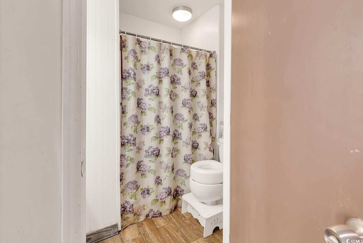 4 Plantation Road Myrtle Beach, SC 29588 - Photo 29 of 40 Full bath with light wood-style floors and a shower with curtain