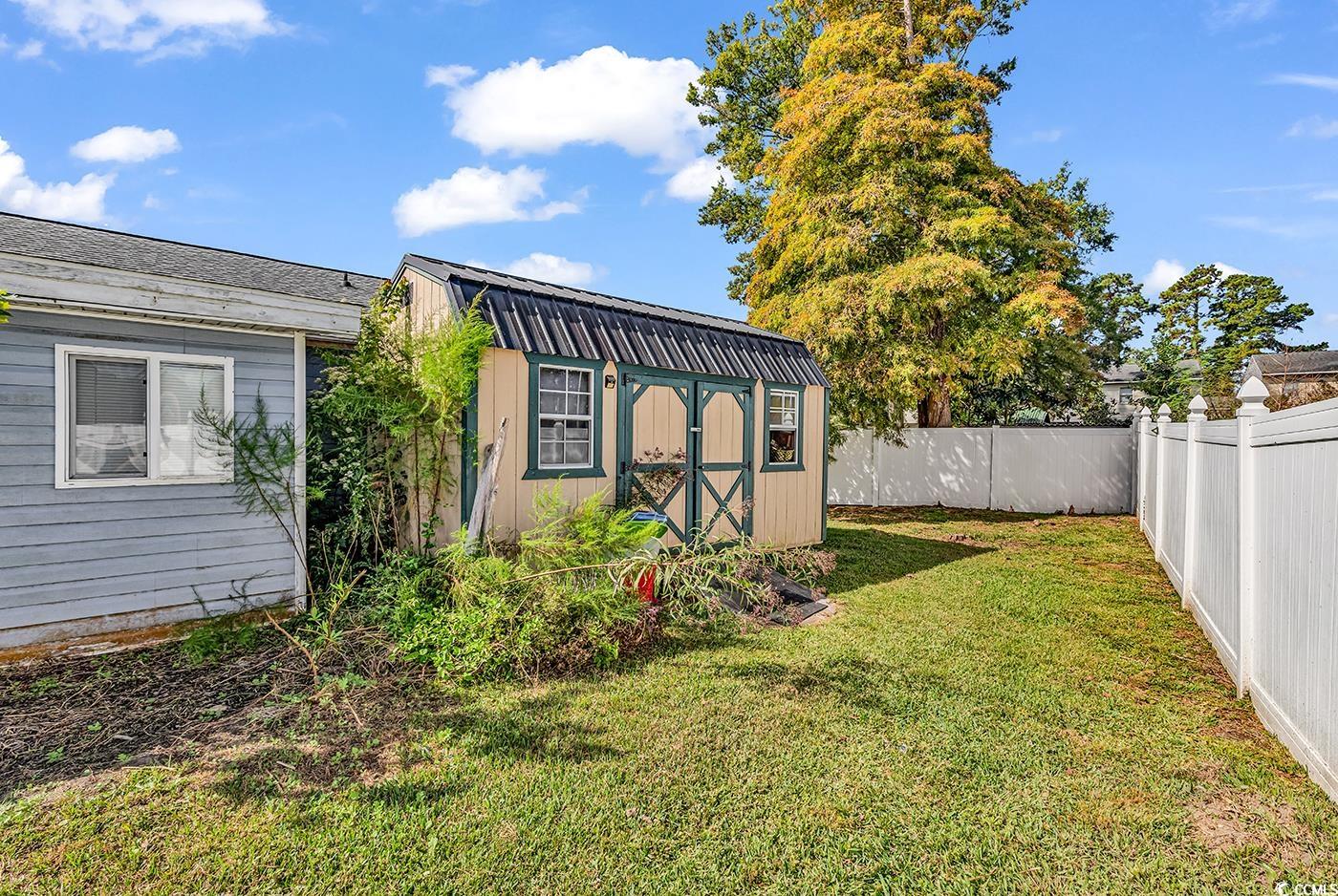 4 Plantation Road Myrtle Beach, SC 29588 - Photo 34 of 40 Fenced backyard featuring a shed