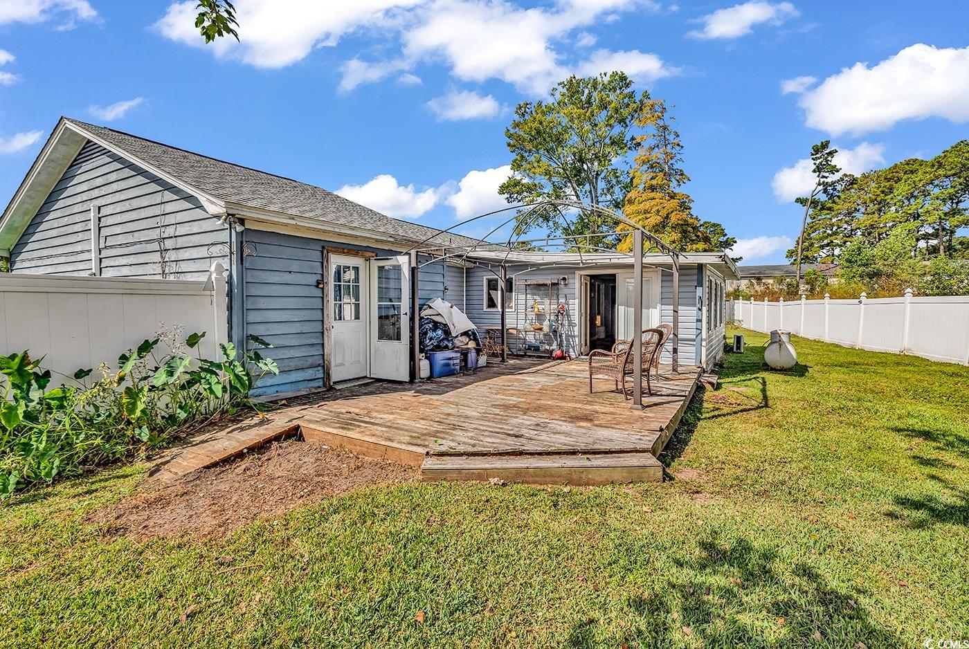 4 Plantation Road Myrtle Beach, SC 29588 - Photo 37 of 40 Rear view of house featuring a fenced backyard and a wooden deck