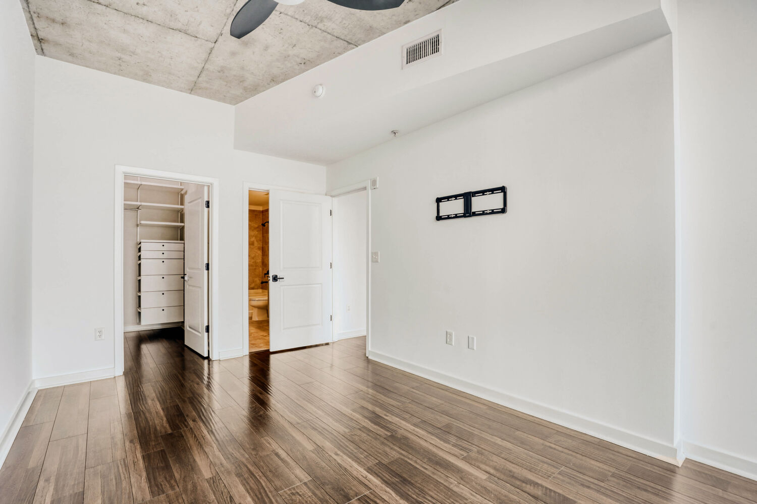 360 Nueces Street, Unit 2004 Austin, TX 78701 - Photo 24 of 34 a view of an empty room with wooden floor