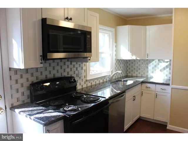 a kitchen with a sink and a stove
