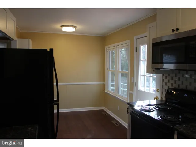 a kitchen with a sink and a refrigerator