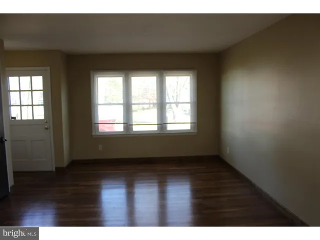 a view of an empty room and wooden floor