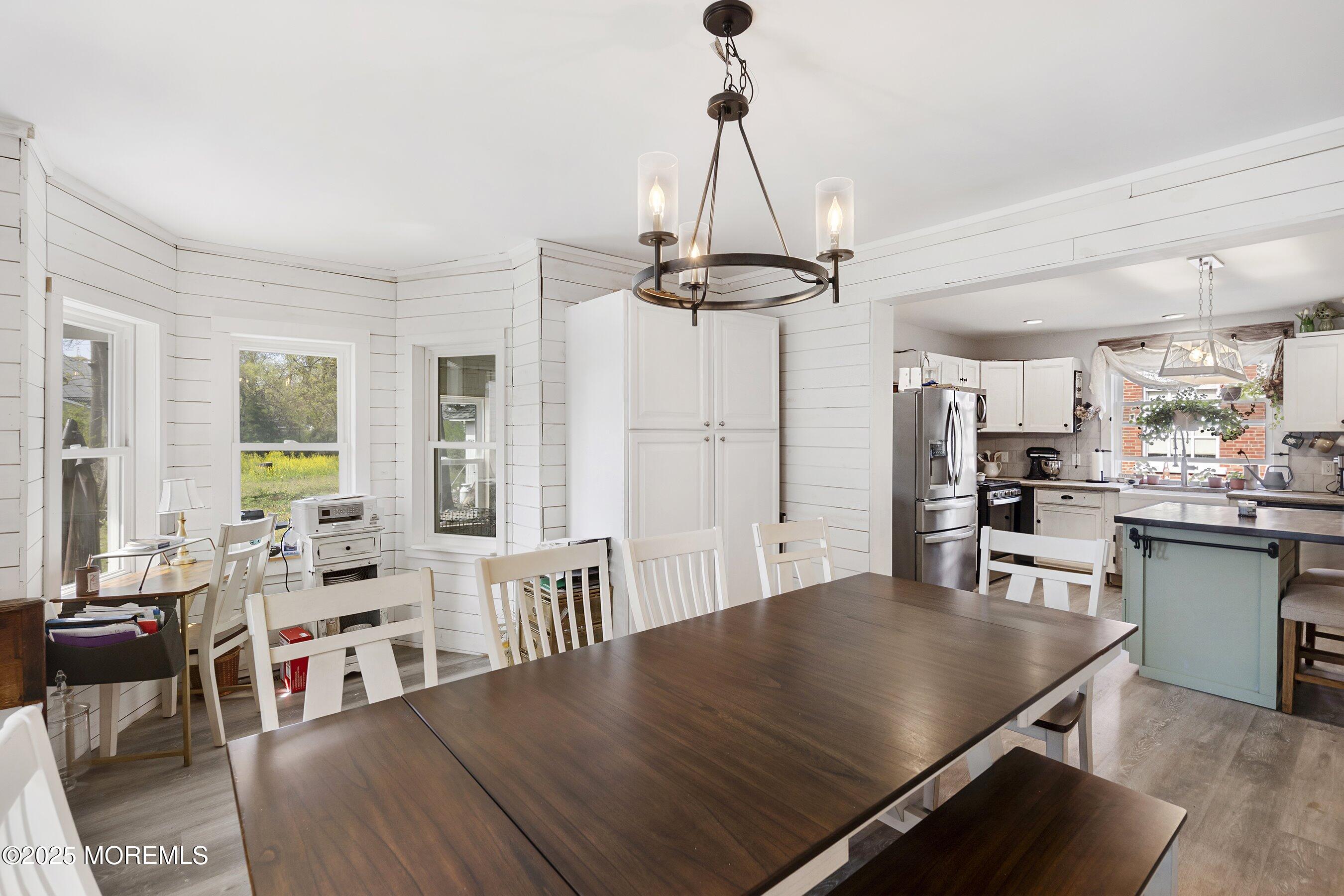 1030 Ocean Road Point Pleasant, NJ 08742 - Photo 14 of 45 a view of a dining room and livingroom with furniture wooden floor a chandelier