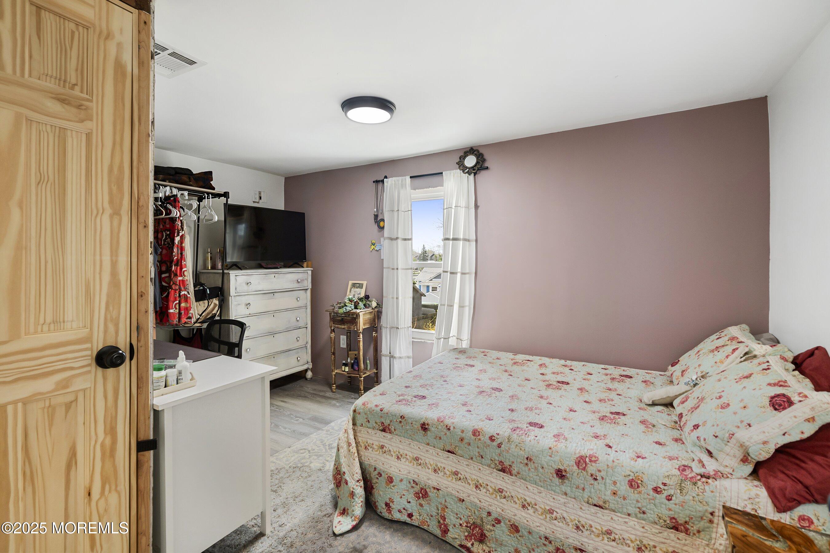 1030 Ocean Road Point Pleasant, NJ 08742 - Photo 19 of 45 a bedroom with a bed and a tv