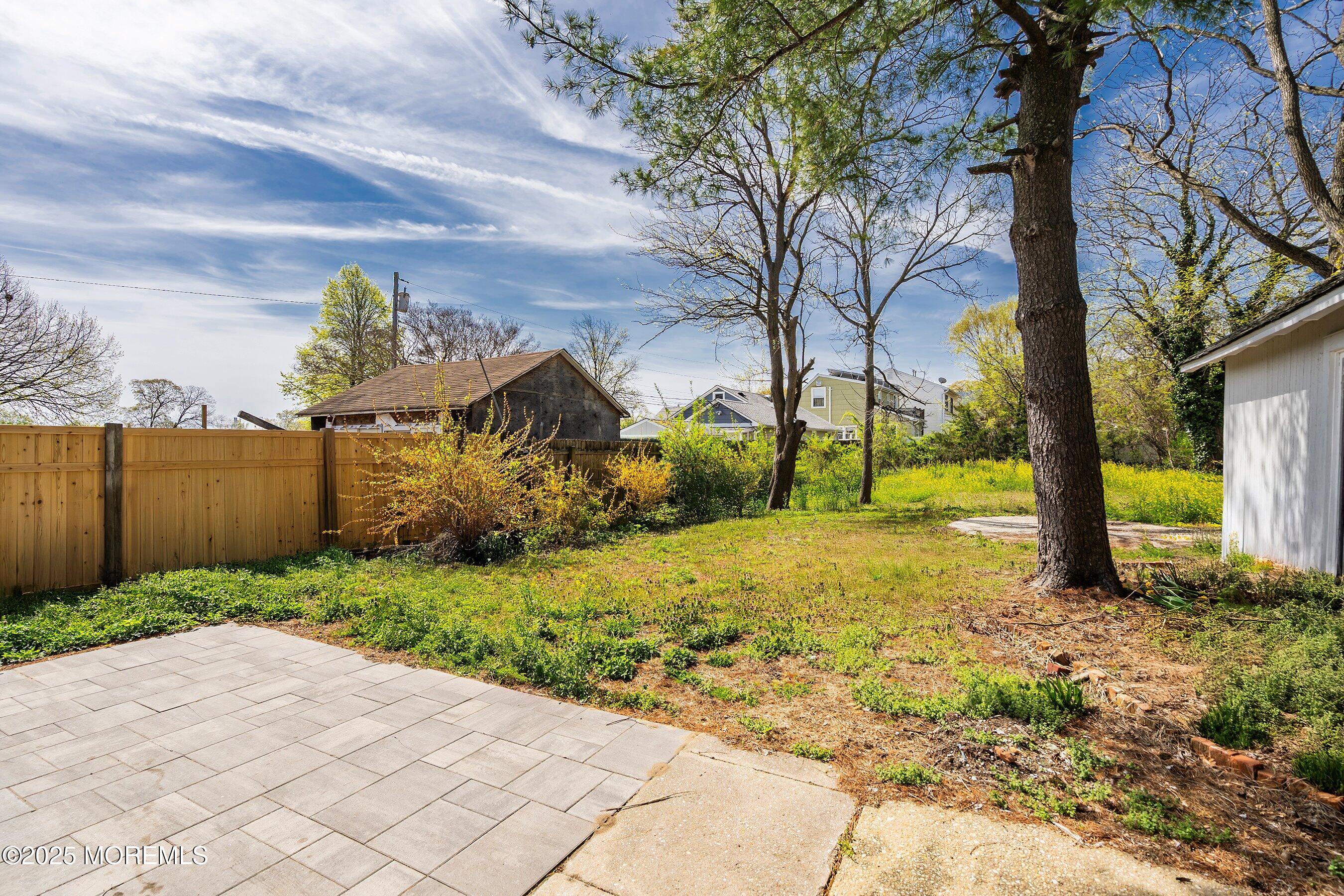 1030 Ocean Road Point Pleasant, NJ 08742 - Photo 23 of 45 a view of a yard with plants and a large tree