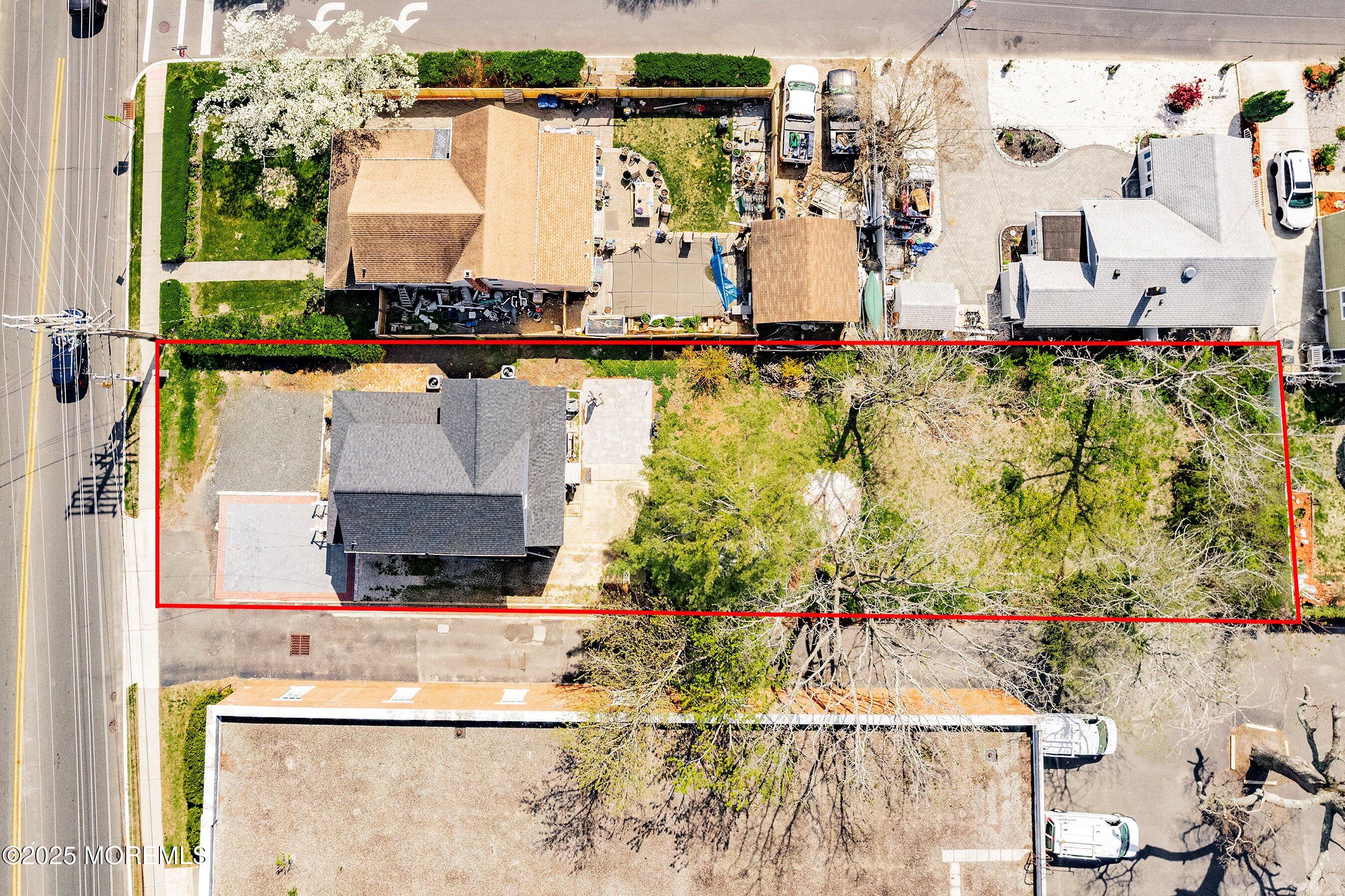 1030 Ocean Road Point Pleasant, NJ 08742 - Photo 27 of 45 an aerial view of a house with a yard and large trees
