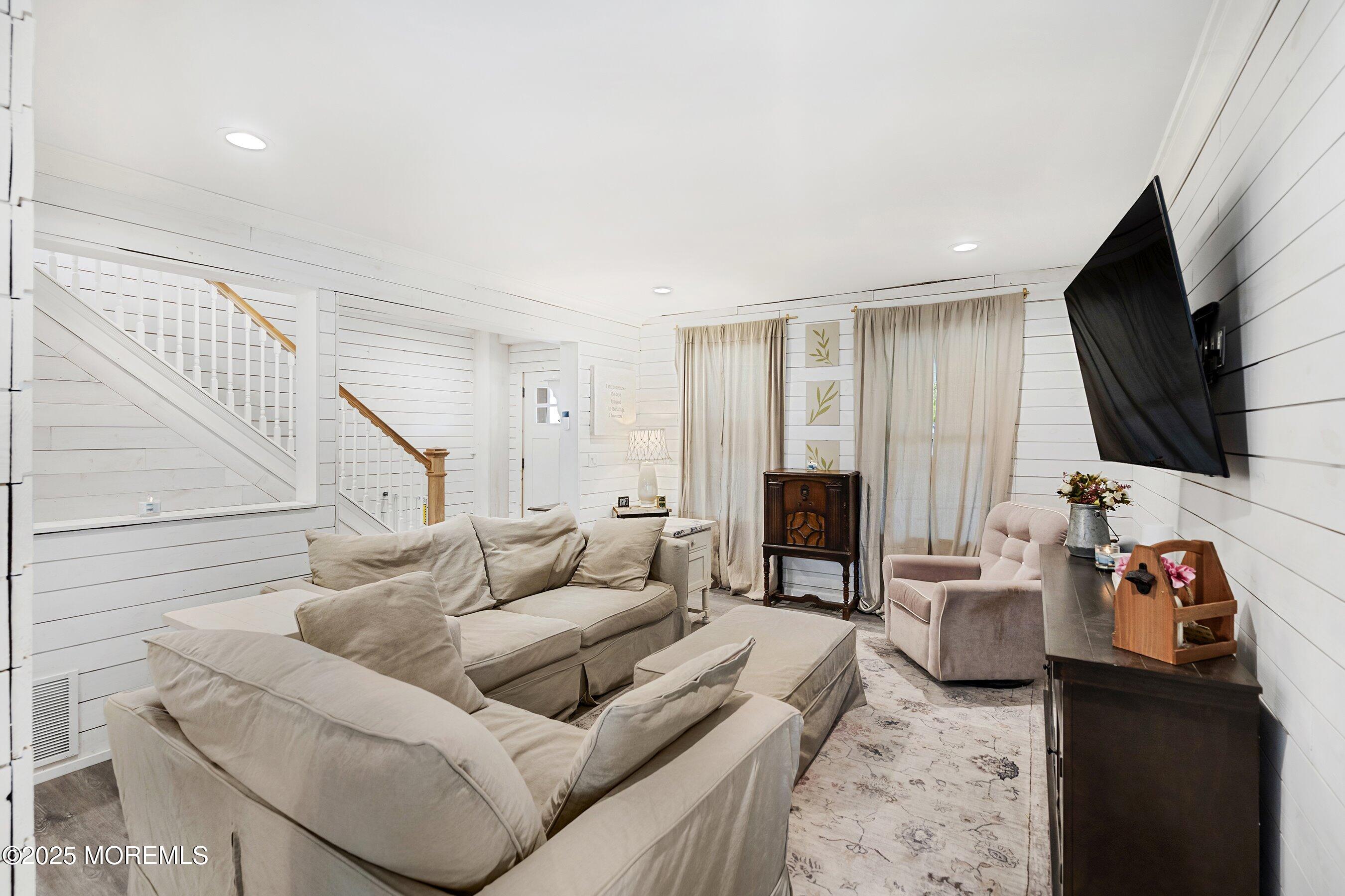 1030 Ocean Road Point Pleasant, NJ 08742 - Photo 5 of 45 a living room with furniture a flat screen tv and a fireplace