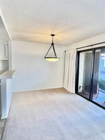 a view of an empty room with glass door