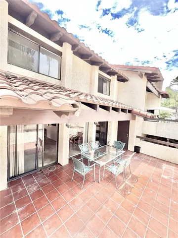a view of a patio with a table and chairs