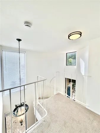 a view of a livingroom with furniture staircase and a ceiling fan