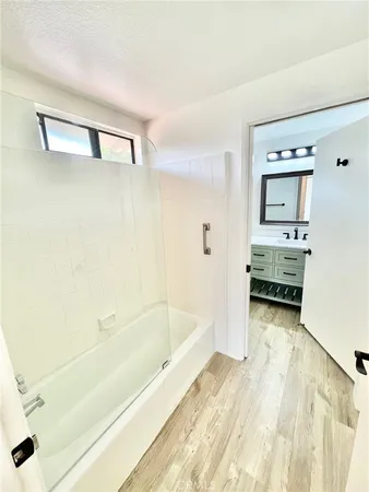 a bathroom with a tub and a shower