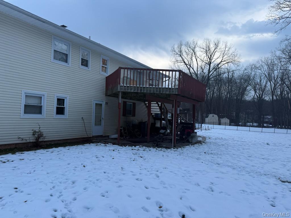 11 Razel Avenue Spring Valley, NY 10977 - Photo 2 of 3 Snow covered rear of property featuring a deck, a patio, and stairway