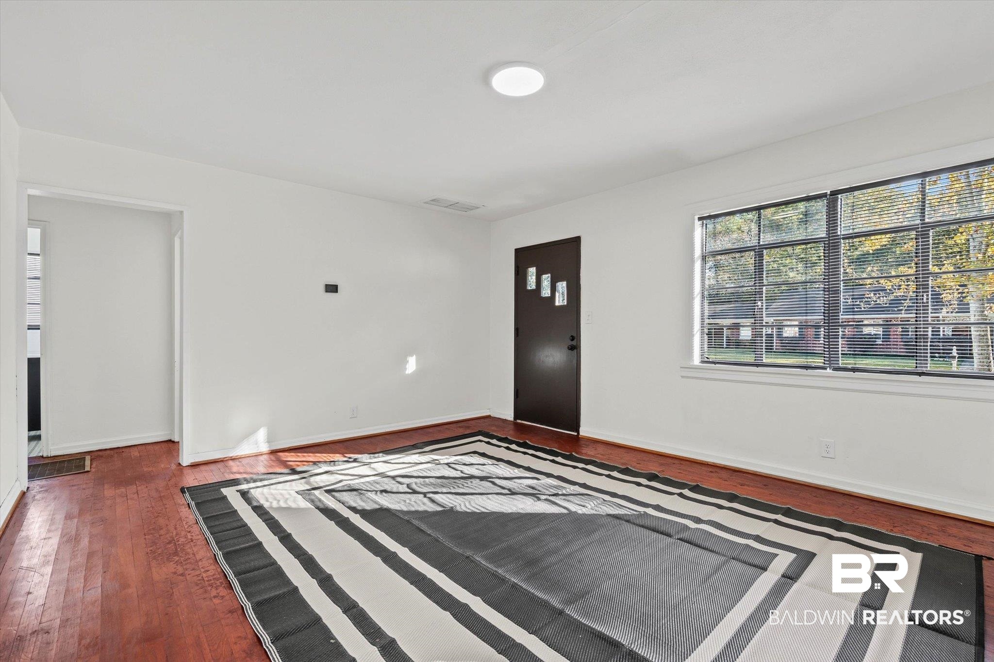 2806 Exter Drive Mobile, AL 36606 - Photo 5 of 24 Entrance foyer with dark wood-style floors and baseboards