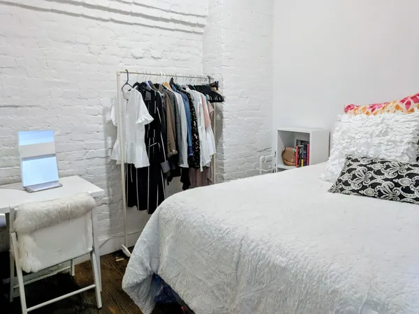 a bed room with a bed and a chair