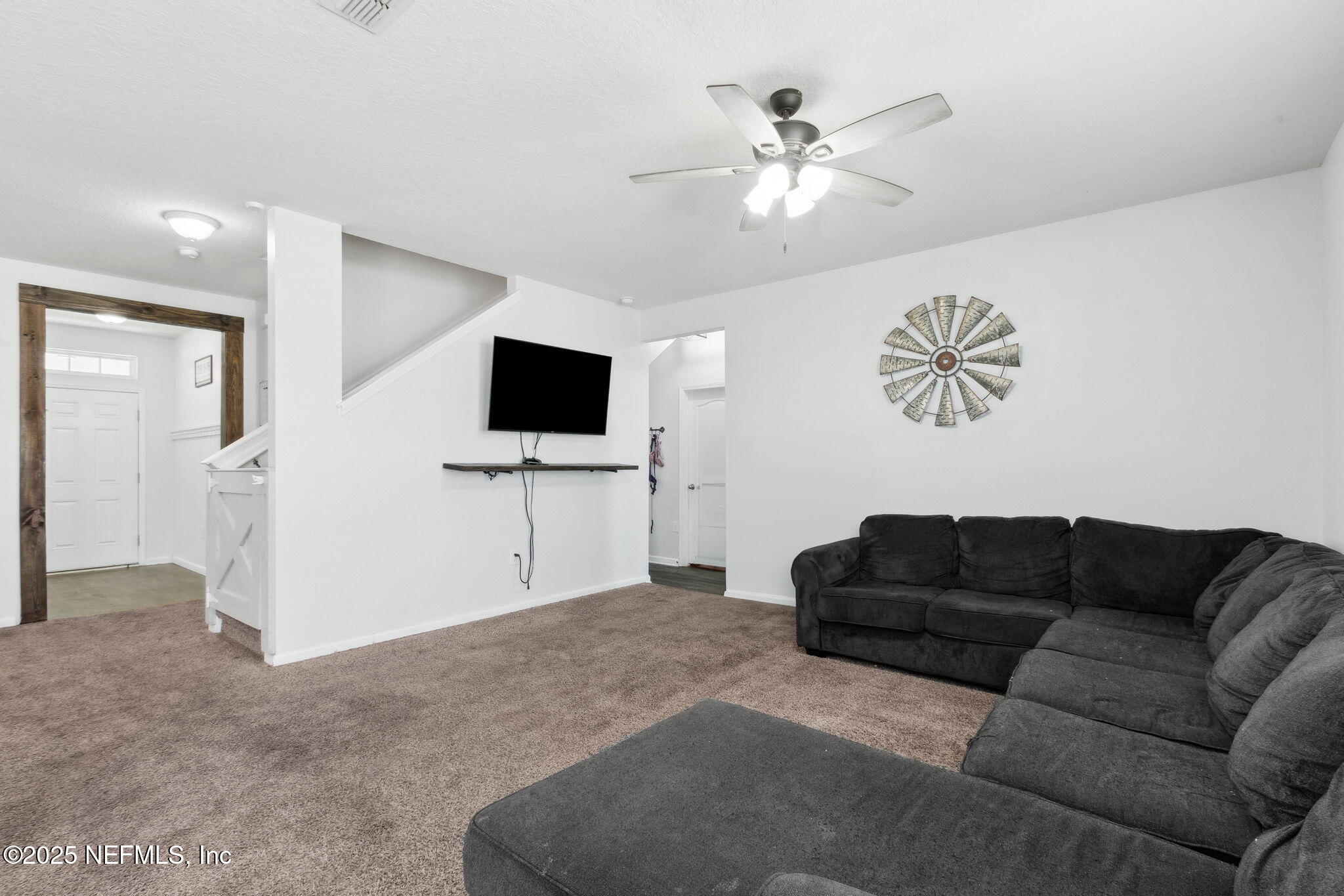 2487 Beachview Drive Jacksonville, FL 32218 - Photo 12 of 39 a living room with furniture and a flat screen tv