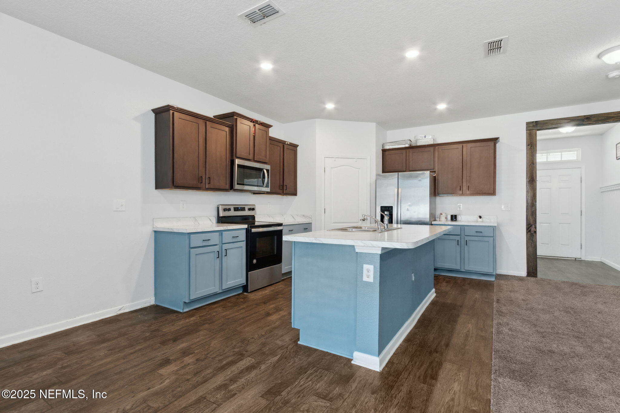 2487 Beachview Drive Jacksonville, FL 32218 - Photo 15 of 39 a kitchen with stainless steel appliances granite countertop a sink dishwasher a stove top oven a refrigerator with grey cabinets and wooden floor