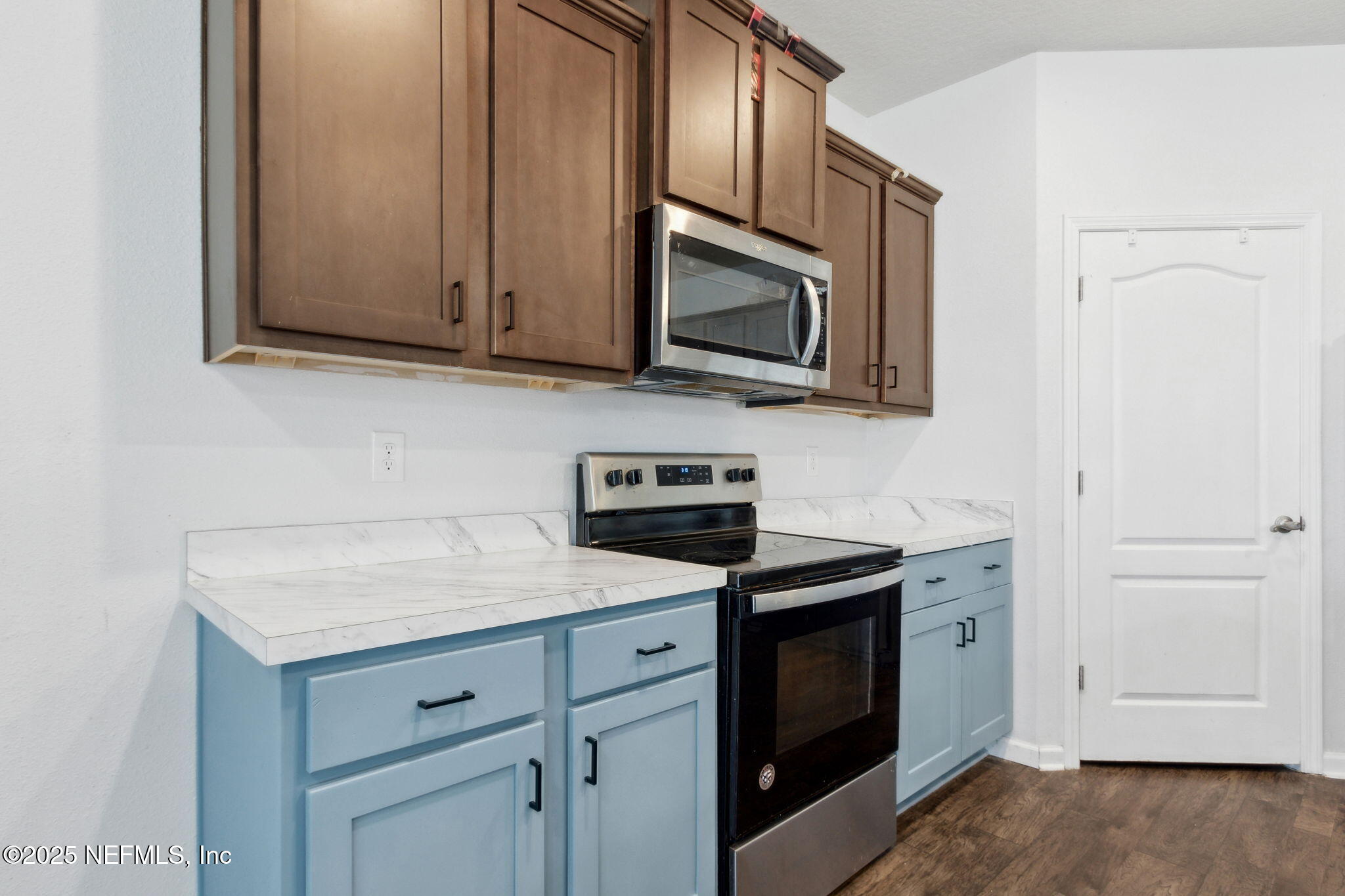 2487 Beachview Drive Jacksonville, FL 32218 - Photo 17 of 39 a kitchen with stainless steel appliances granite countertop white cabinets a microwave oven and a sink with wooden cabinets