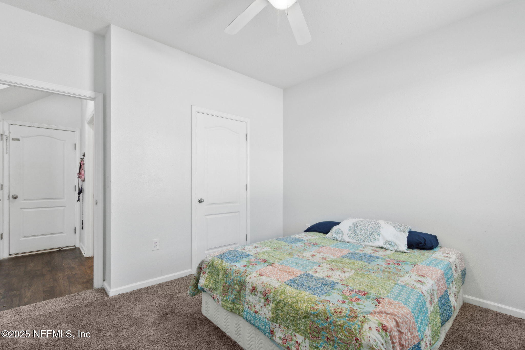 2487 Beachview Drive Jacksonville, FL 32218 - Photo 21 of 39 a bedroom with a bed and a chandelier fan
