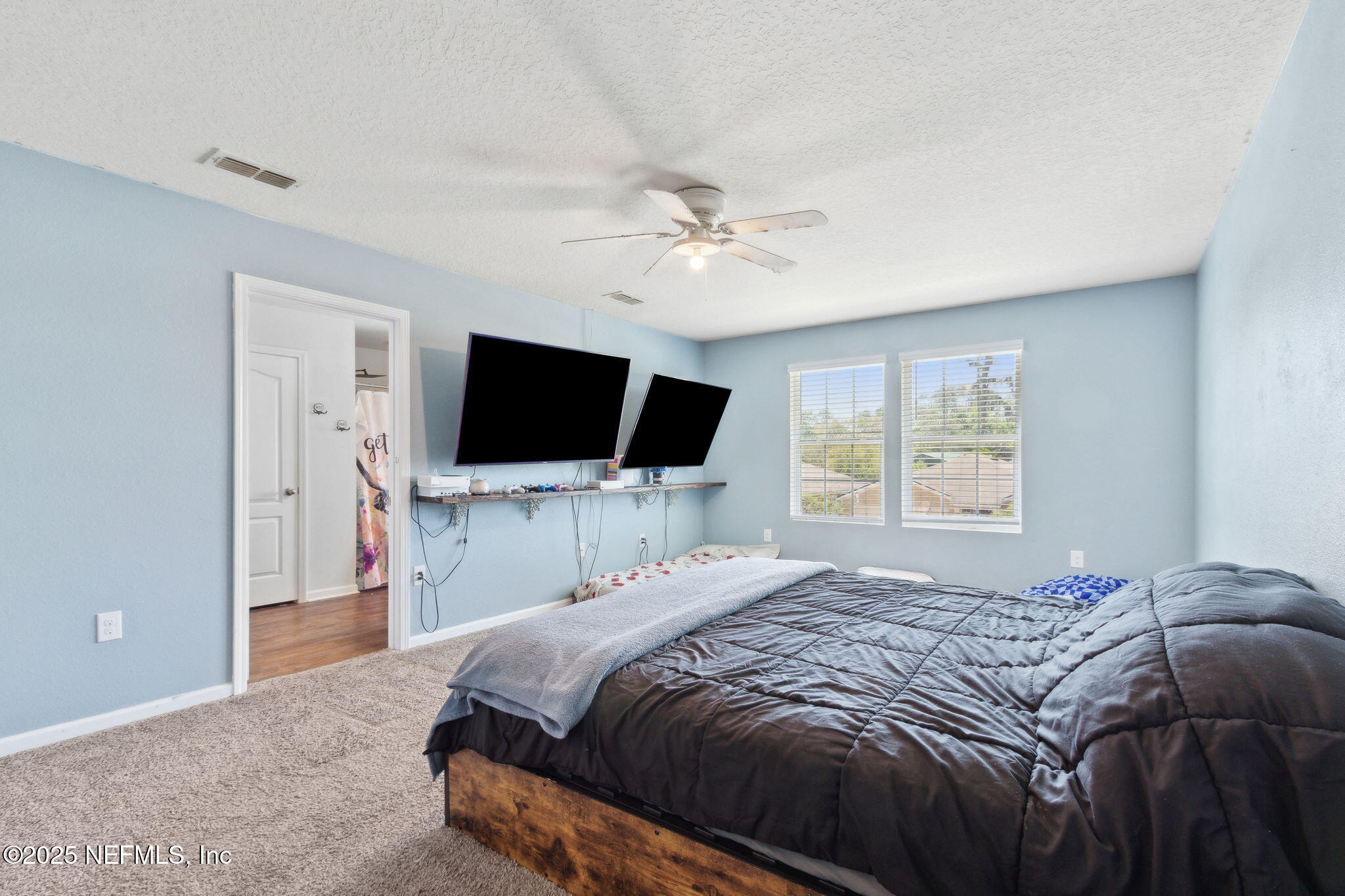 2487 Beachview Drive Jacksonville, FL 32218 - Photo 24 of 39 a bedroom with a bed tv and a window