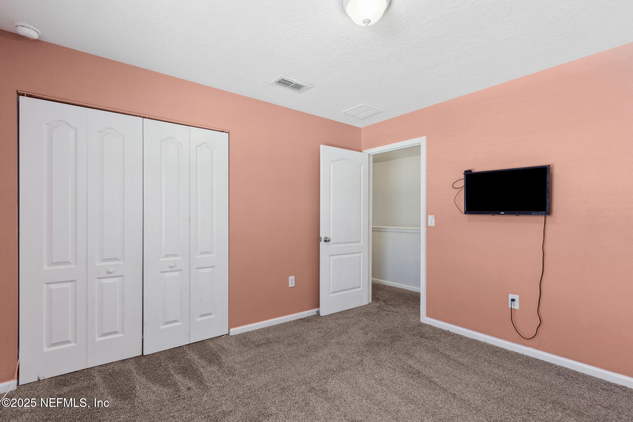 2487 Beachview Drive Jacksonville, FL 32218 - Photo 28 of 39 a view of an empty room with an empty space and a flat screen tv