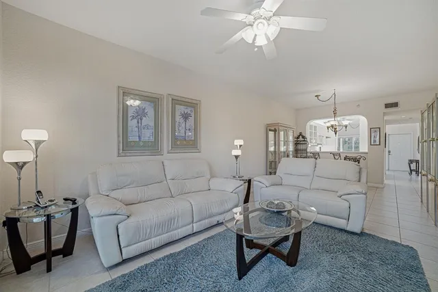 a living room with furniture and a chandelier