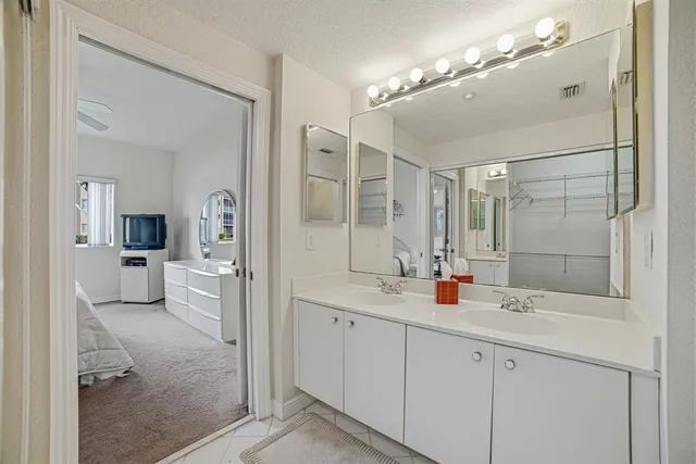 a spacious bathroom with a sink shower and a mirror