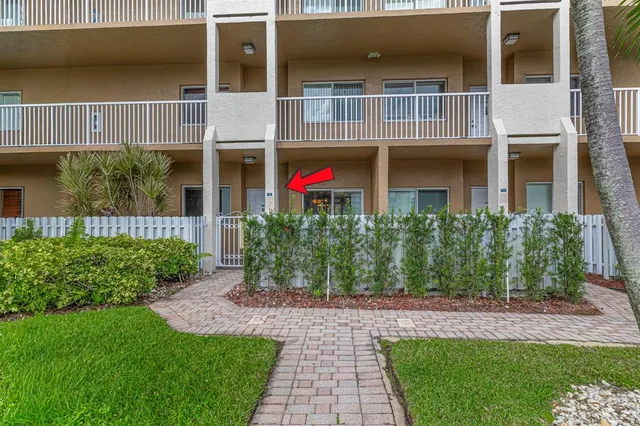 a front view of a house with a yard and plants
