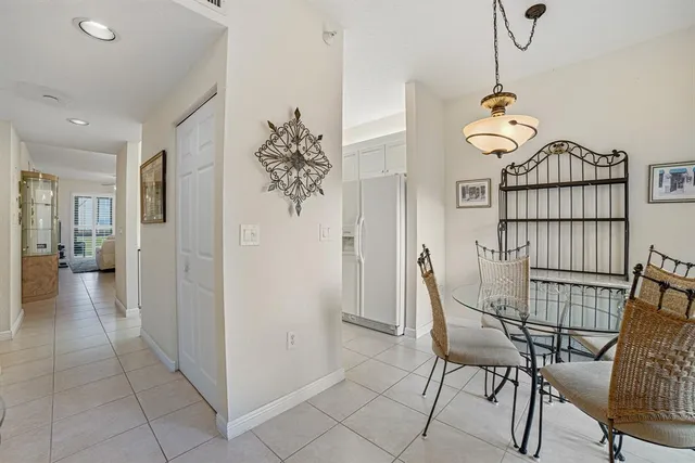 a view of a hallway to a livingroom with furniture
