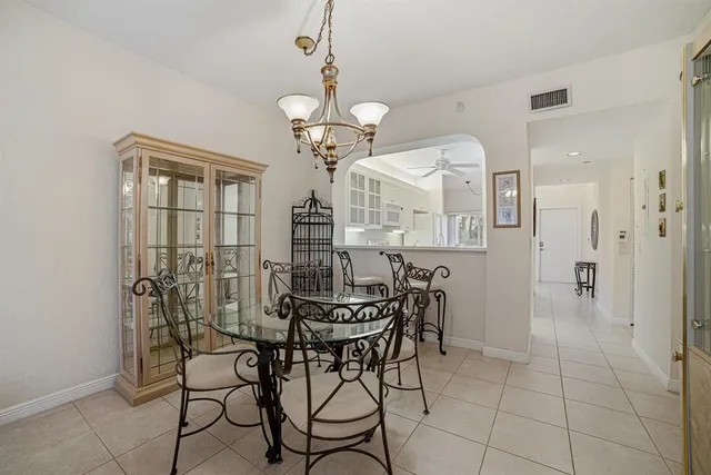 a view of a dining room with furniture and chandelier