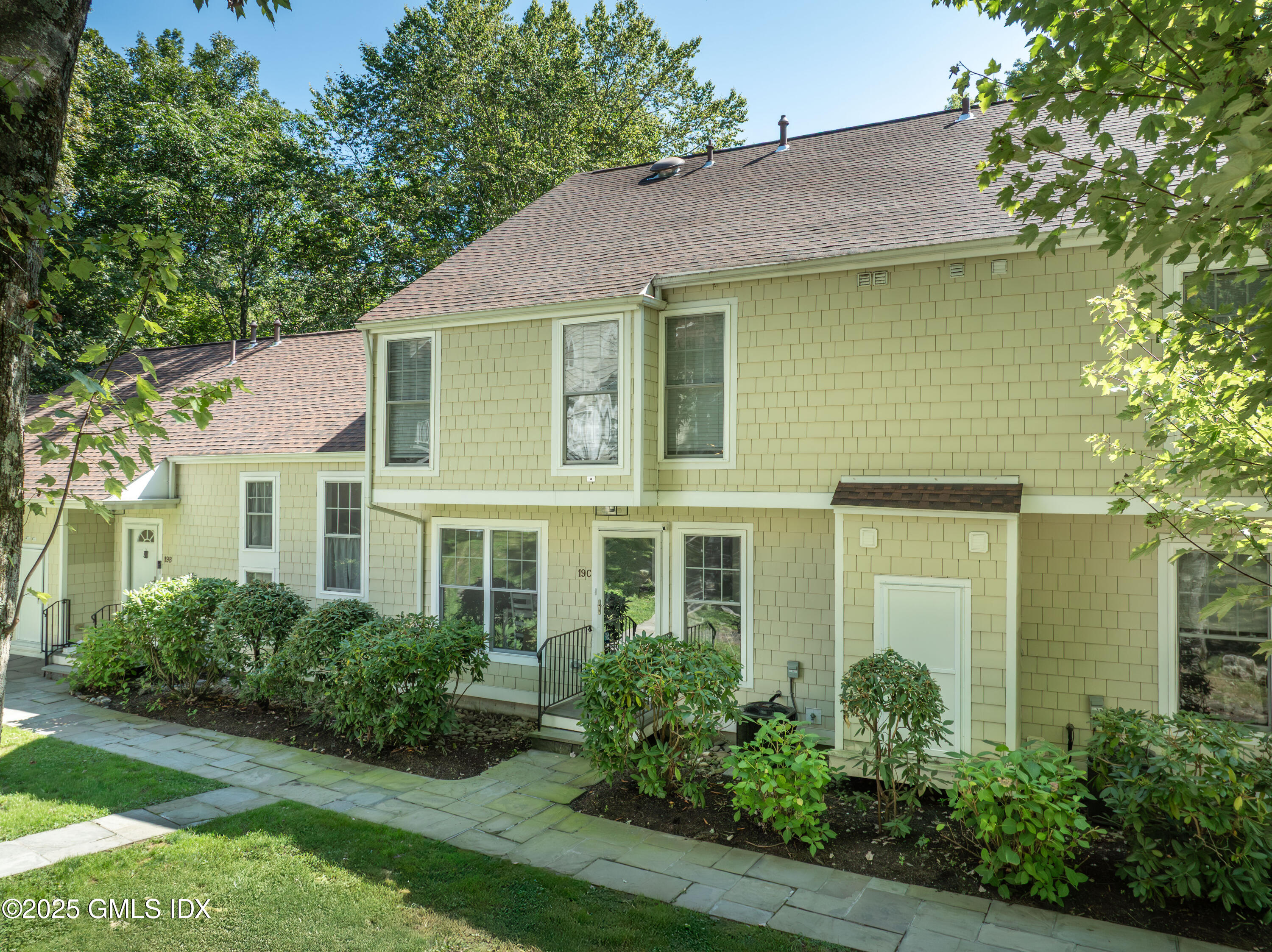 221 Weaver Street, Unit 19C Greenwich, CT 06831 - Photo 1 of 23 a front view of a house with a yard