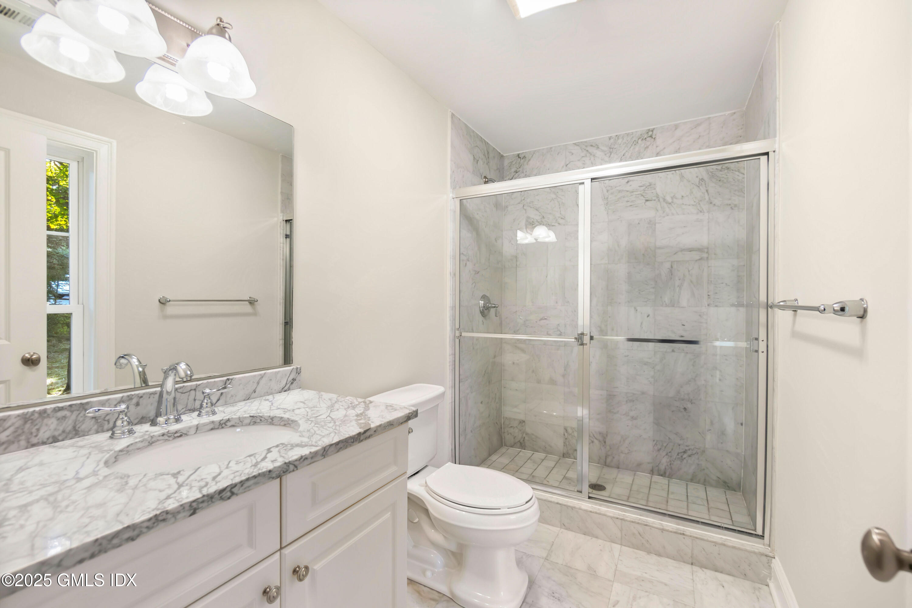 221 Weaver Street, Unit 19C Greenwich, CT 06831 - Photo 10 of 23 a bathroom with a granite countertop sink a toilet and shower