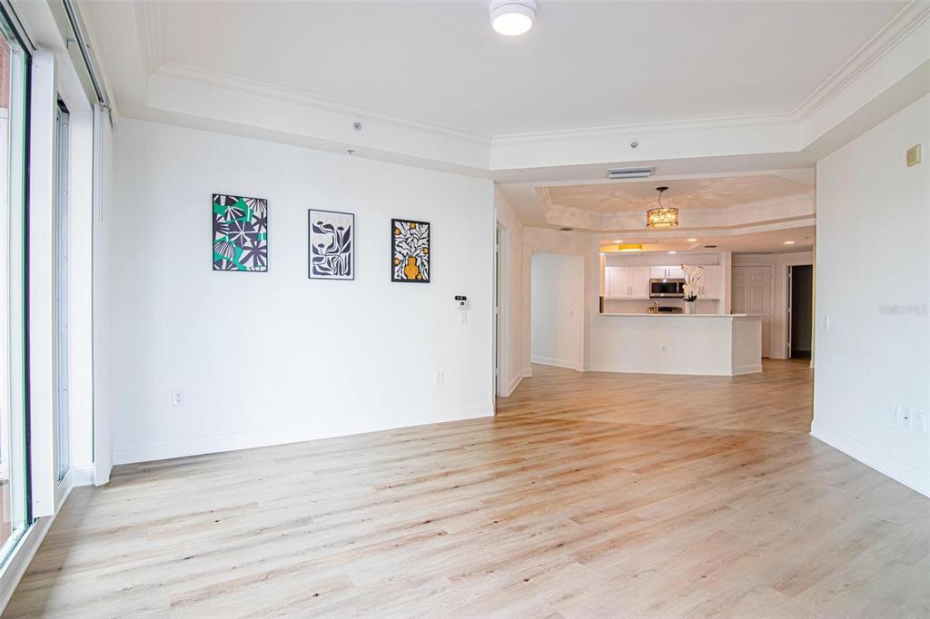 2743 First Street, Unit 406 Fort Myers, FL 33916 - Photo 26 of 52 a view of a big room with wooden floor and a kitchen