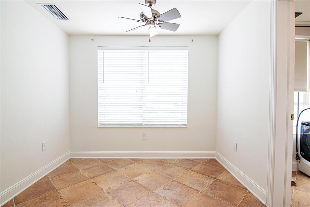 2743 First Street, Unit 406 Fort Myers, FL 33916 - Photo 28 of 52 an empty room with a window and a fan
