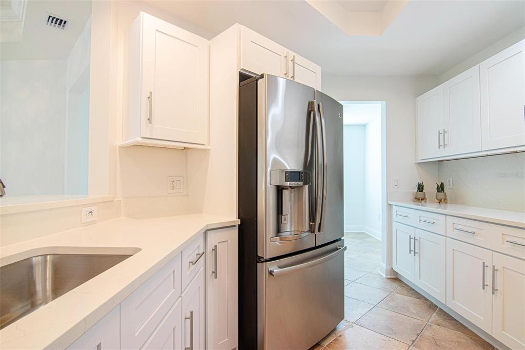 2743 First Street, Unit 406 Fort Myers, FL 33916 - Photo 44 of 52 a kitchen with appliances cabinets and a sink