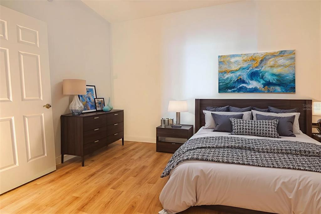 2743 First Street, Unit 406 Fort Myers, FL 33916 - Photo 49 of 52 a bedroom with a bed and wooden floor