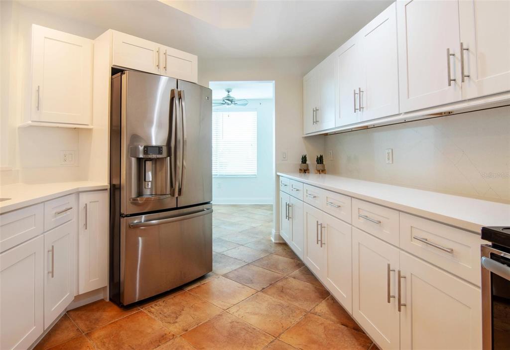 2743 First Street, Unit 406 Fort Myers, FL 33916 - Photo 10 of 52 a kitchen with cabinets and stainless steel appliances