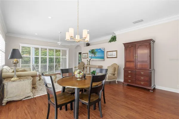 a kitchen with stainless steel appliances white cabinets a sink a stove a refrigerator and white cabinets