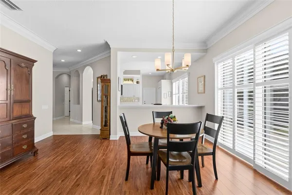 a living room with furniture wooden floor and a large window