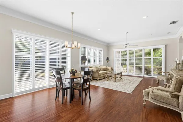a kitchen with white cabinets stainless steel appliances and a window