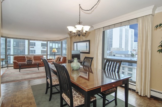 1310 North Ritchie Court, Unit 14C Chicago, IL 60610 - Photo 11 of 22 a view of a dining room with furniture window and wooden floor