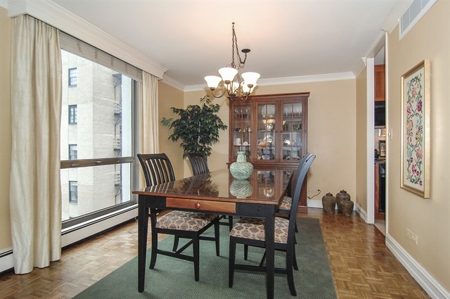 1310 North Ritchie Court, Unit 14C Chicago, IL 60610 - Photo 15 of 22 a view of a dining room with furniture window and wooden floor